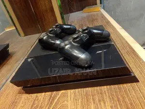 Photo - PlayStation 4 Fat Console with Games and Accessories Bundle