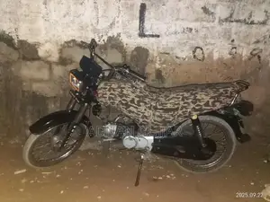 Photo - Black Motorcycle with Clear Engine and Paperwork