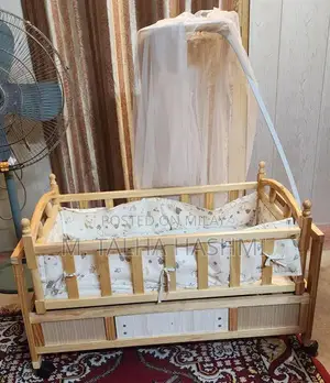 Photo - Wooden Baby Cot with Mosquito Net and Storage Drawer