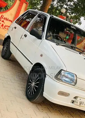 Photo - Mehran White Sedan with Alloy Rims and LCD Display