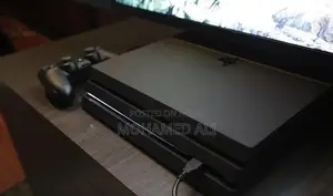 Photo - PlayStation 4 Pro 1TB 4K HDR Gaming Console