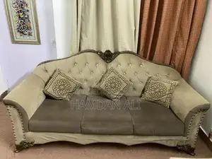 Elegant Velvet Sofa with Carved Wood Frame and Shiny Buttons