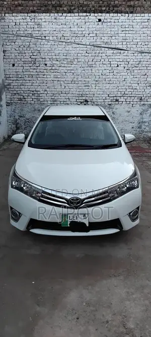 Photo - Toyota Corolla Gli 16 White Sedan with Manual Transmission