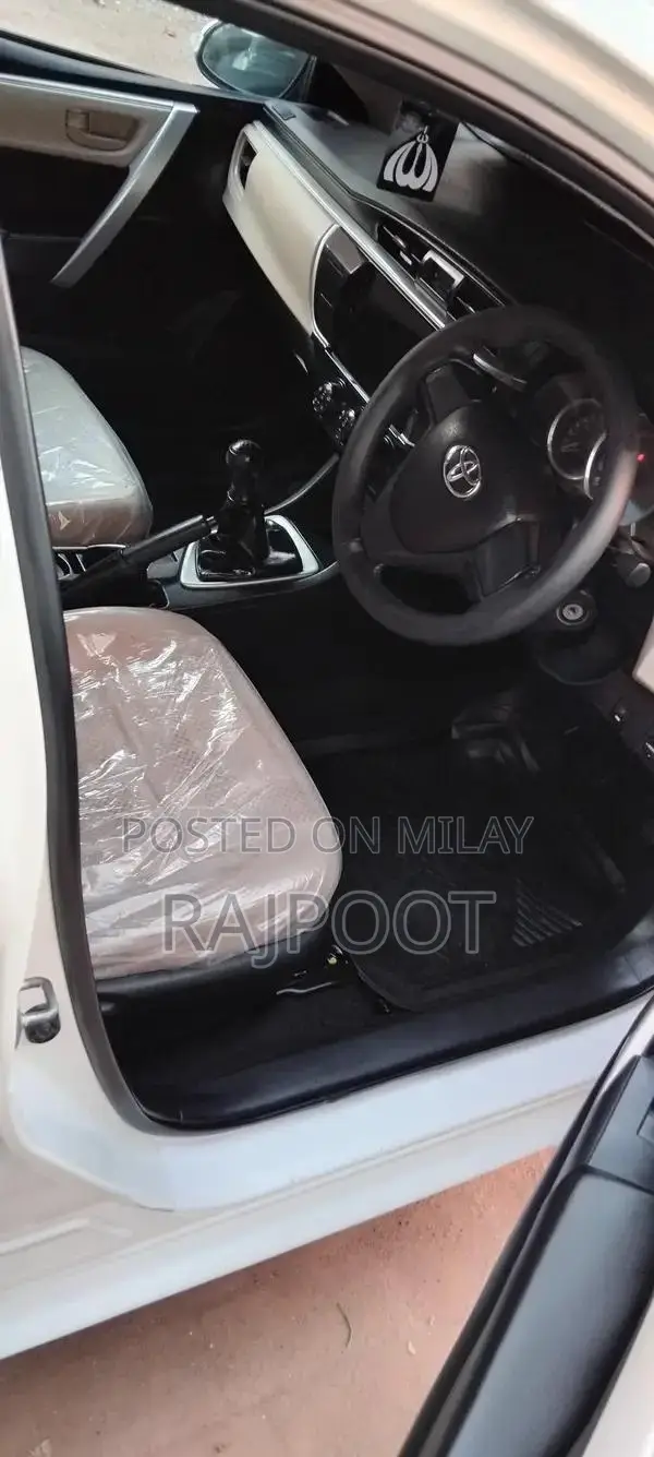 Toyota Corolla Gli 16 White Sedan with Manual Transmission