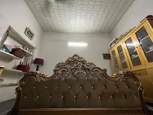 Luxury King Size Bed with Carved Wooden Headboard and Side Tables
