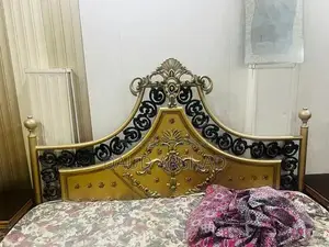 Photo - Iron and wood bed