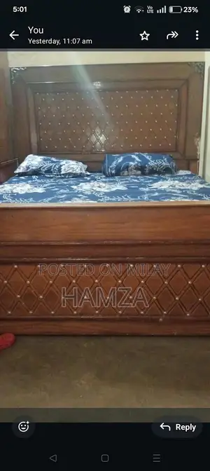 Photo - wooden bed with side table