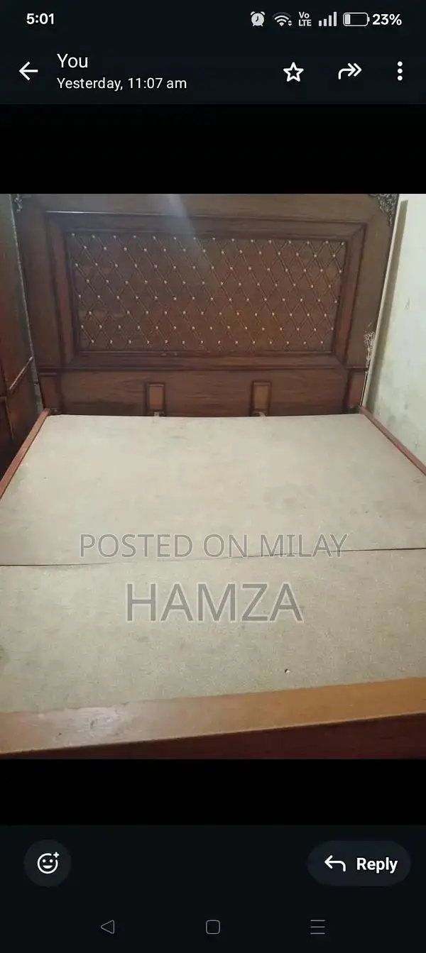 wooden bed with side table