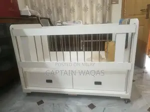 Photo - Baby Crib with Storage - Compact and Versatile Infant Bed