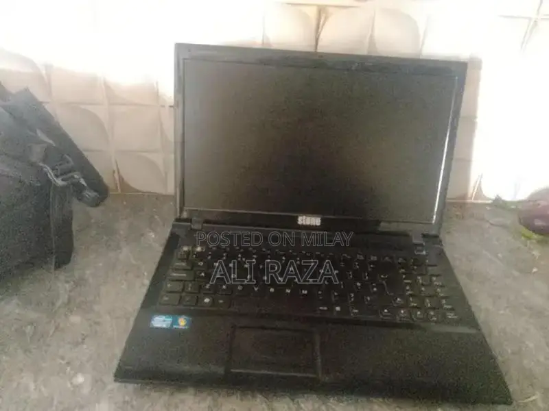 Stone Laptop with Missing Buttons - Portable Computing Device
