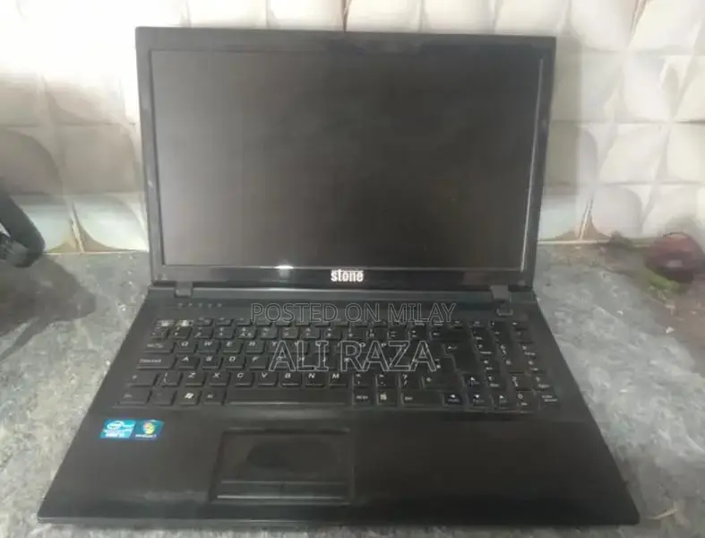 Stone Laptop with Missing Buttons - Portable Computing Device