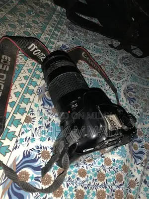 Photo - Canon EOS 1300D DSLR Camera with 75-300mm Zoom Lens