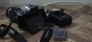 Photo - Olympus Digital Camera with Lens, Battery, and Charger