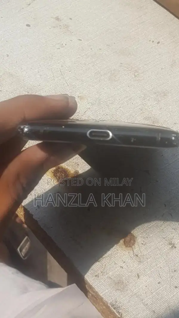 Damaged Sony Smartphone with Broken Panel and Back