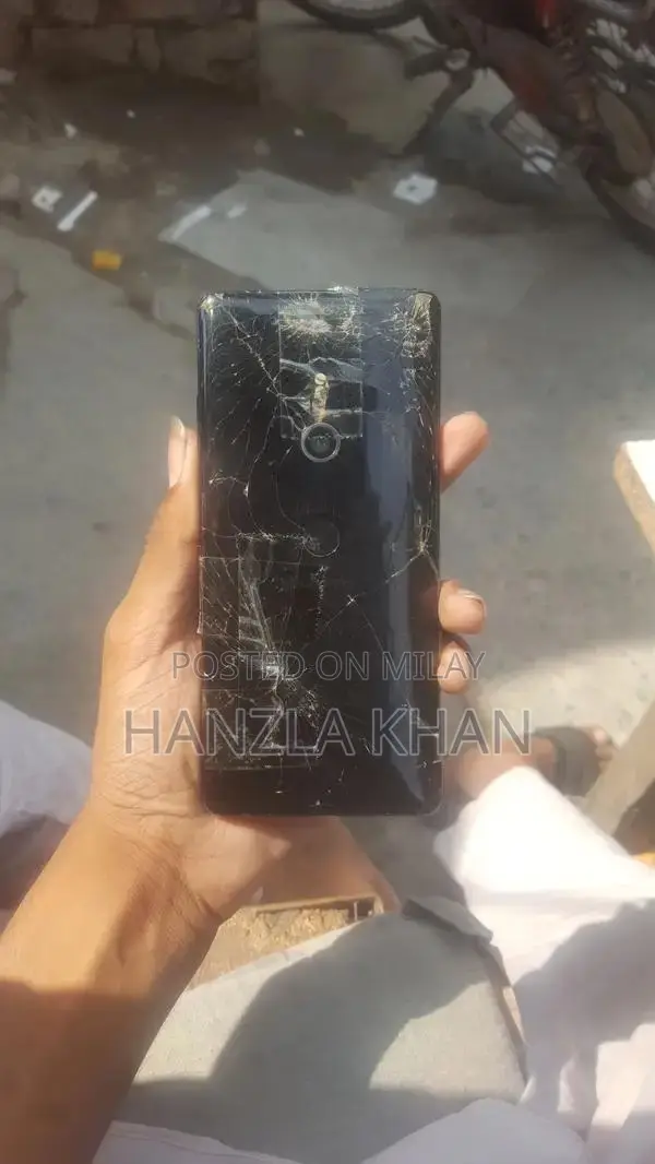 Damaged Sony Smartphone with Broken Panel and Back