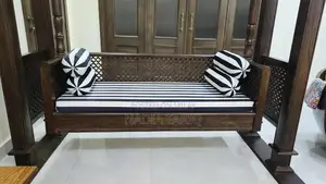 Wooden Swing with Striped Seat and Decorative Pillows