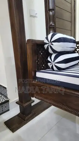 Wooden Swing with Striped Seat and Decorative Pillows