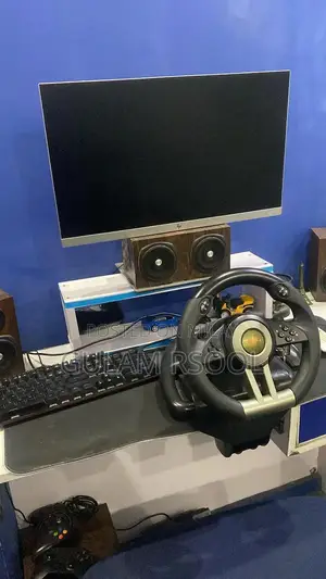 Complete Gaming PC Setup with Steering Wheel and Peripherals
