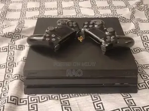 Photo - PlayStation 4 Pro Gaming Console 1TB with Dual Controllers